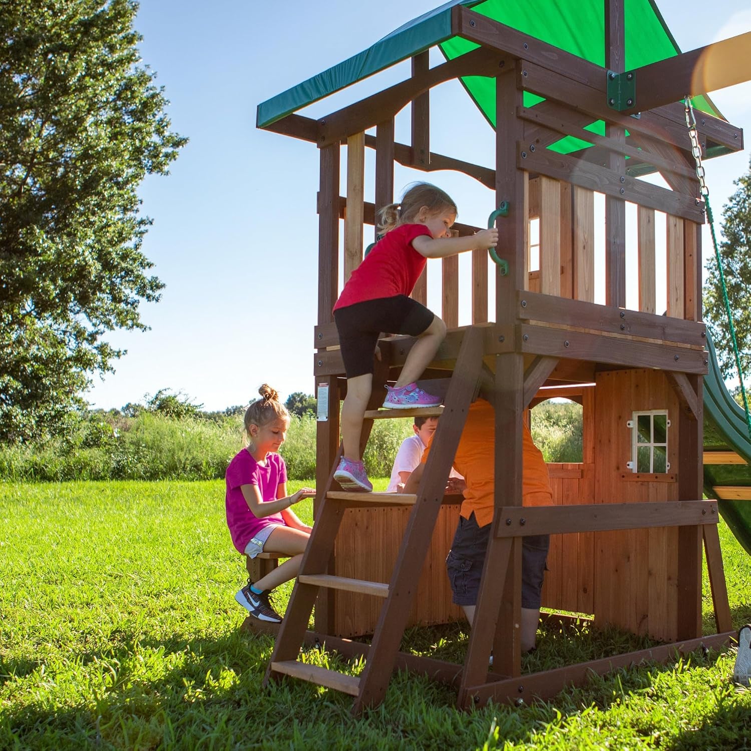 Lakewood Cedar Wood Swing Set, Covered Upper Deck with White Trim Window, Slide with Rails, Lower Fort Area with Door and Attached Bench, Swing Belts, Trapeze Bar, Stair Ladder